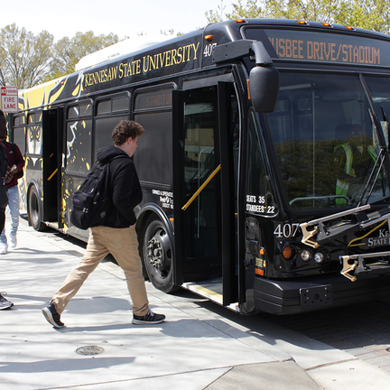 Student getting on the Big Owl Bus